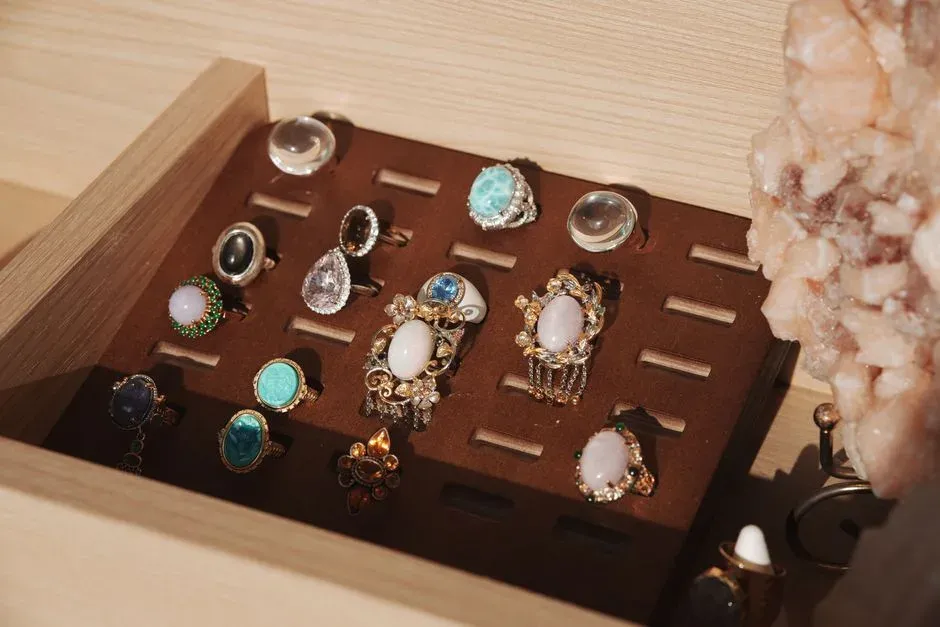 Assorted colored gemstone rings in a display tray