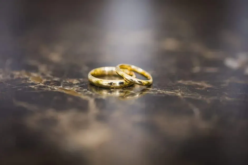 Two gold bands on a dark surface