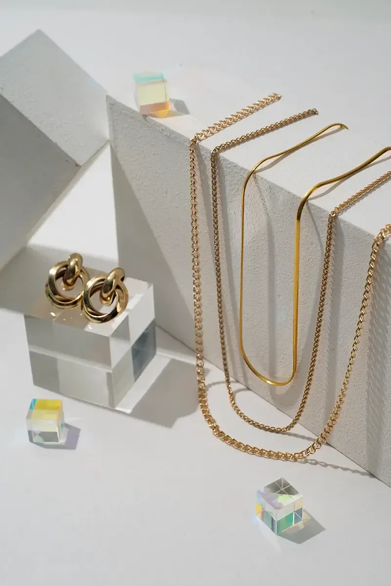 Gold-tone necklaces and earrings on display blocks