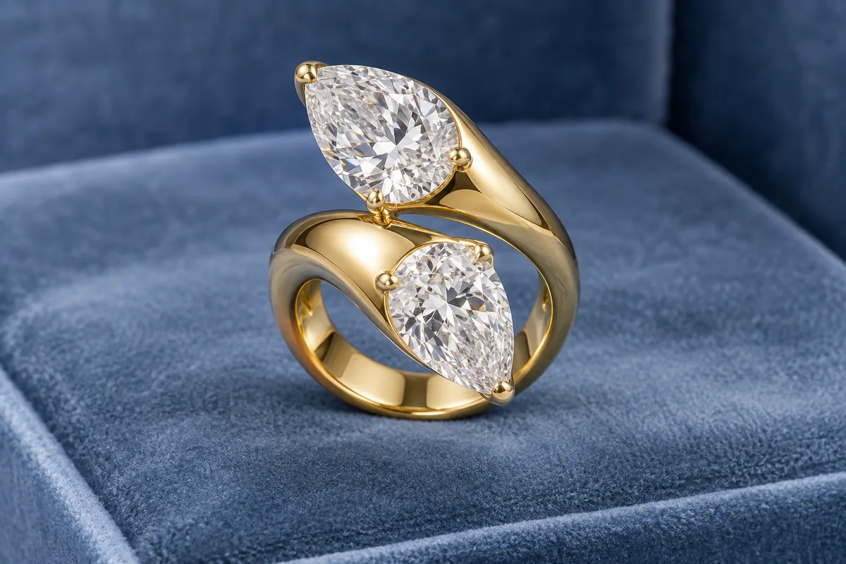 Sculptural yellow-gold bypass ring with two large opposing pear-shaped diamonds