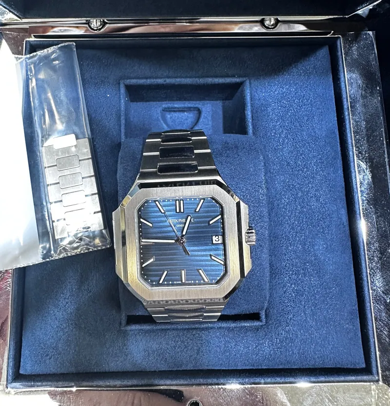 Blue-dial Patek Philippe-branded wristwatch in a blue presentation box