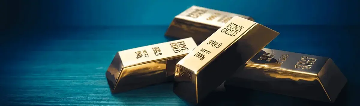 Stacked gold bars against a dark blue background